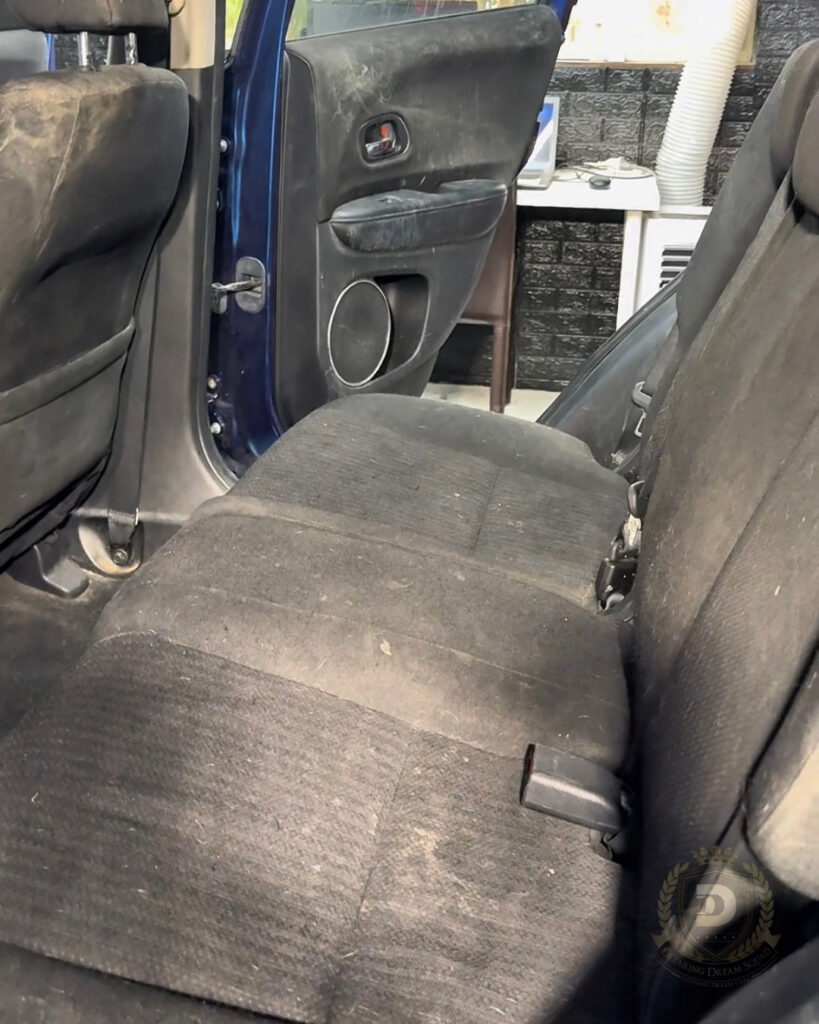 Dirty rear car seats and door panel covered in dust and stains before interior detailing by Detailing Dream Squad in Sydney