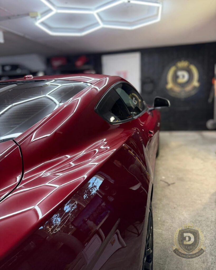 Red Ford Mustang with high gloss ceramic coated paint and strong roof reflections