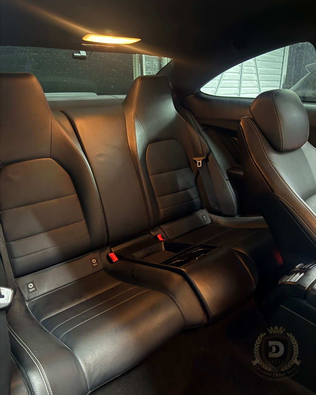 Clean black leather rear seats after a full interior detailing service by Detailing Dream Squad in Baulkham Hills.
